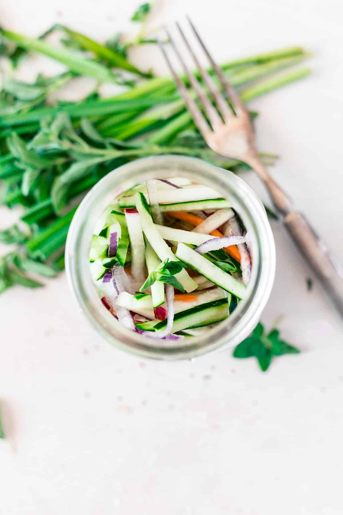 Quick pickled cucumbers and onions made with optional carrots and radishes make the perfect addition to salads, sandwiches, and more!