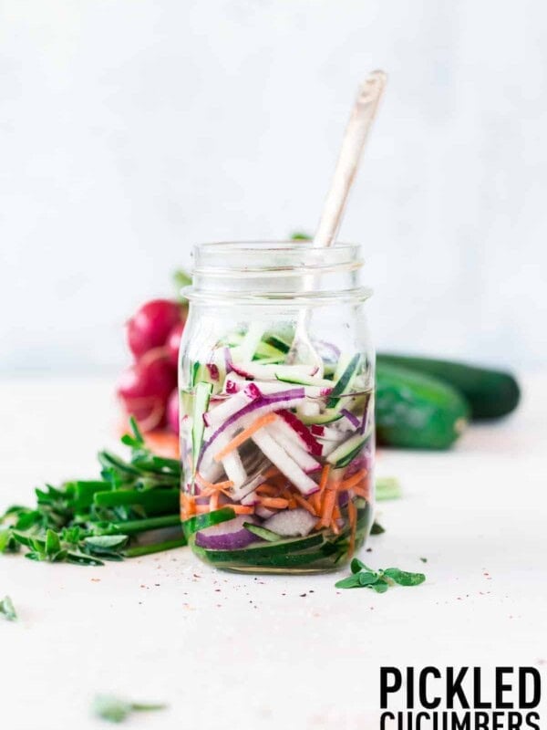 Quick pickled cucumbers and onions made with optional carrots and radishes make the perfect addition to salads, sandwiches, and more!