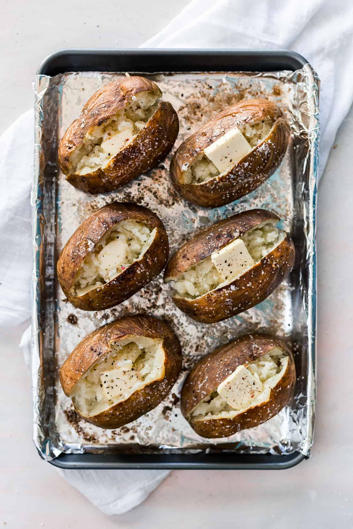 The perfect Steakhouse Baked Potato that is crispy on the outside and extra fluffy in the middle, made with only 3 simple ingredients and done in less than an hour!