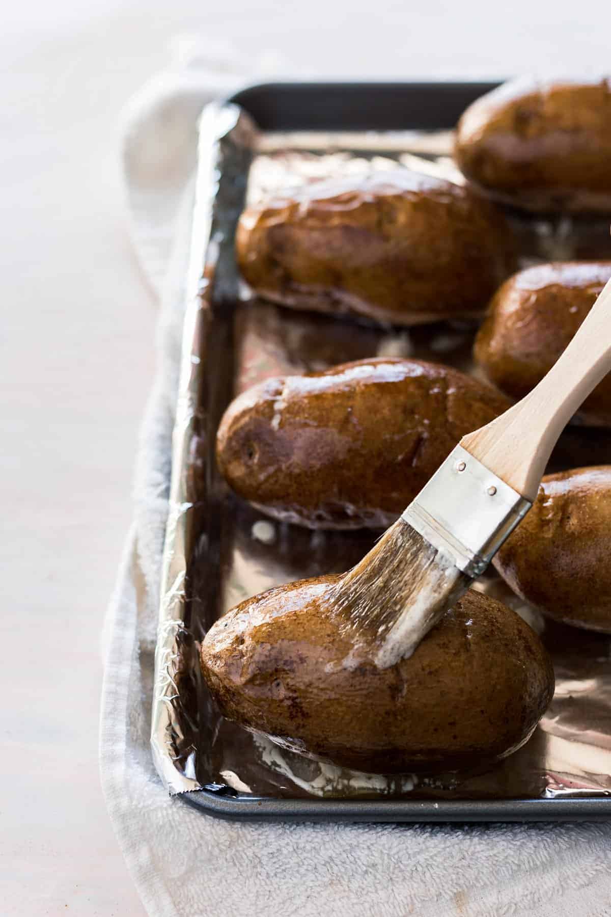 The perfect Steakhouse Baked Potato that is crispy on the outside and extra fluffy in the middle, made with only 3 simple ingredients and done in less than an hour!