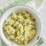 Bowl of potato salad with eggs and pickles