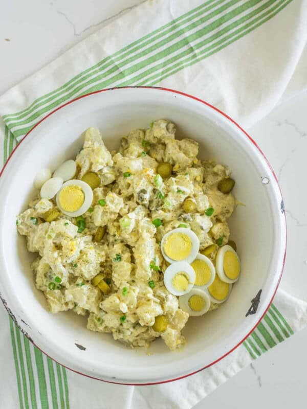 Bowl of potato salad with eggs and pickles