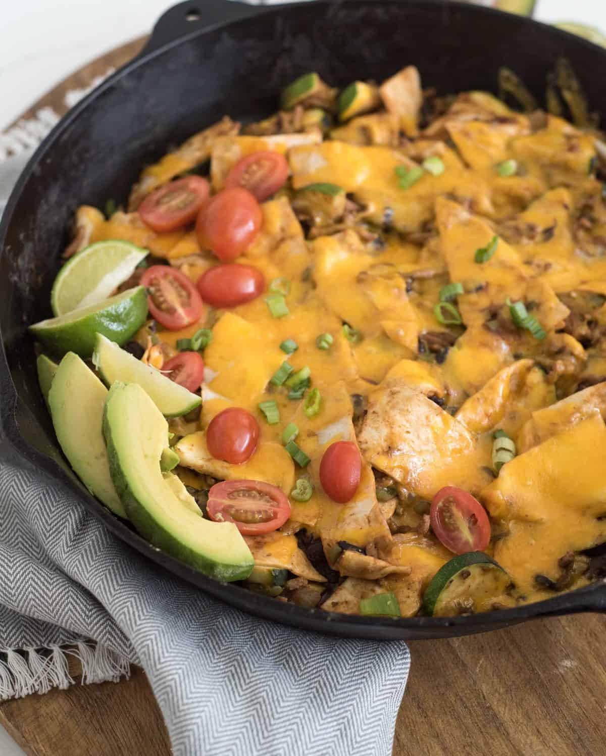 One pan chicken enchilada casserole made on the stove top with ground chicken, enchilada sauce, veggies, and tortillas in less than 30 minutes.