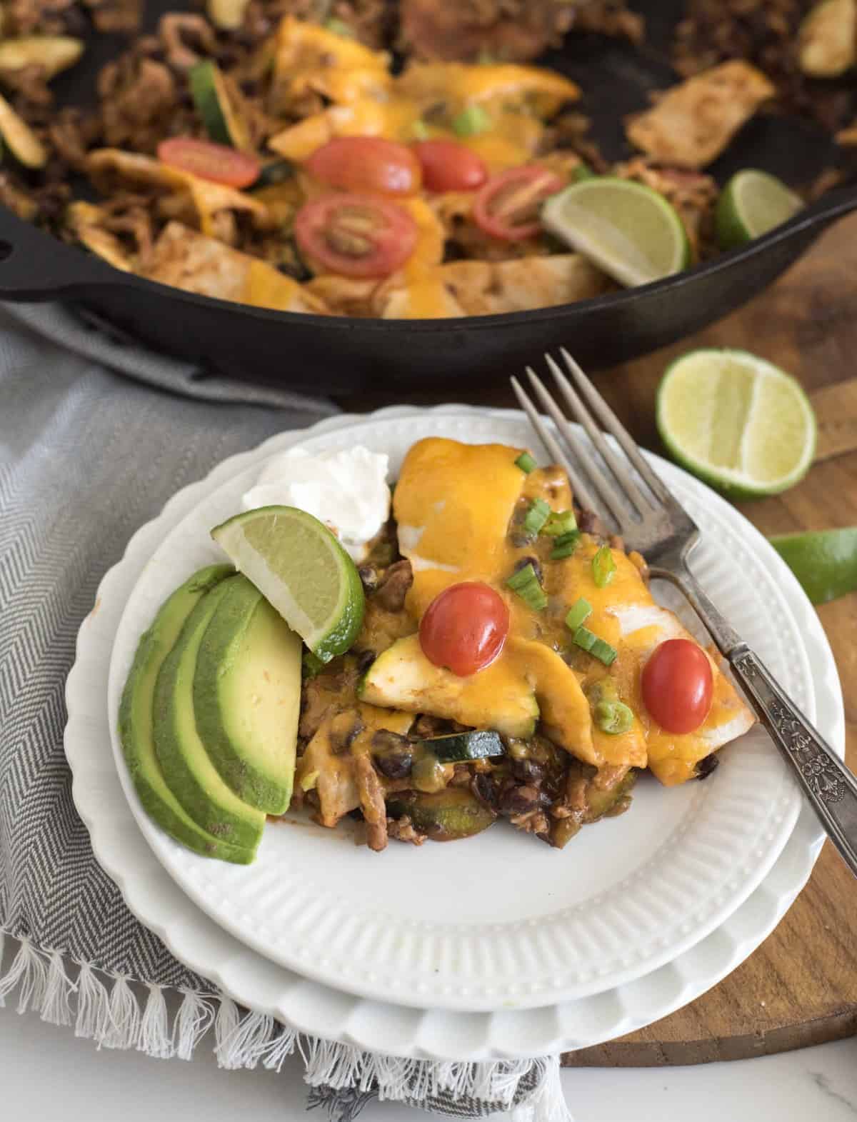 One pan chicken enchilada casserole made on the stove top with ground chicken, enchilada sauce, veggies, and tortillas in less than 30 minutes.