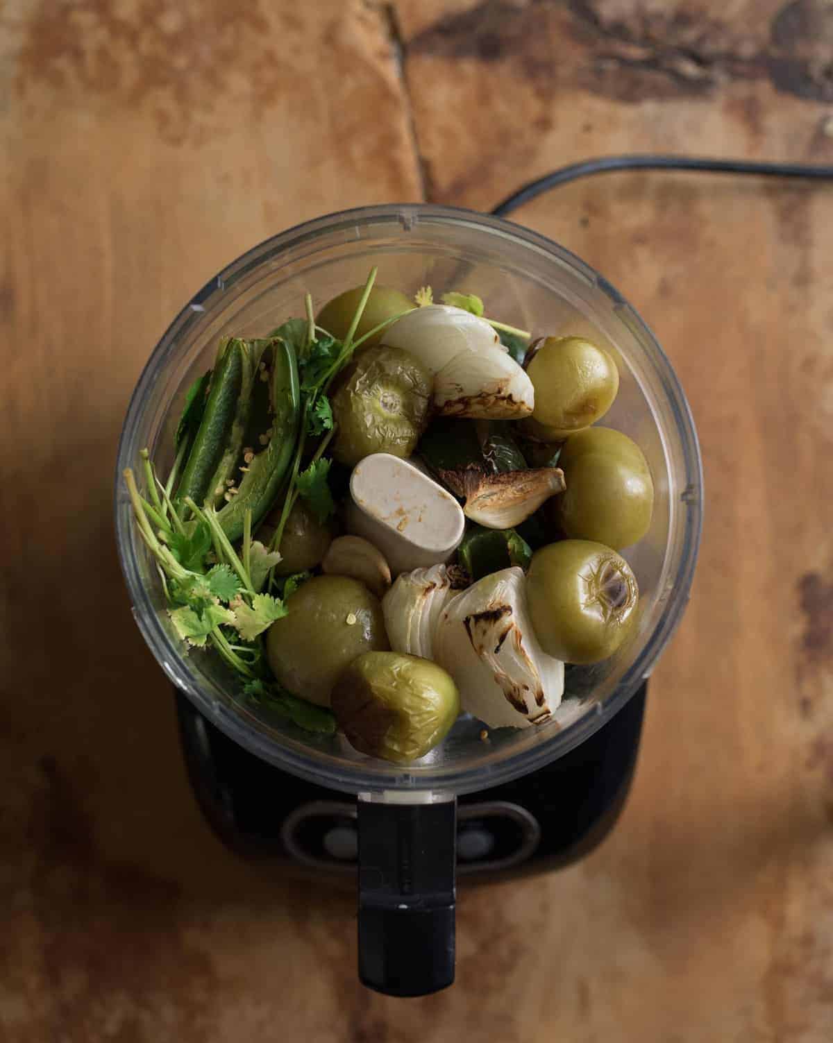 Quick and easy salsa verde recipe made with oven roasted tomatillos, peppers, onion, and garlic all blended to salsa perfection with a mix of herbs, spices, and lime juice.