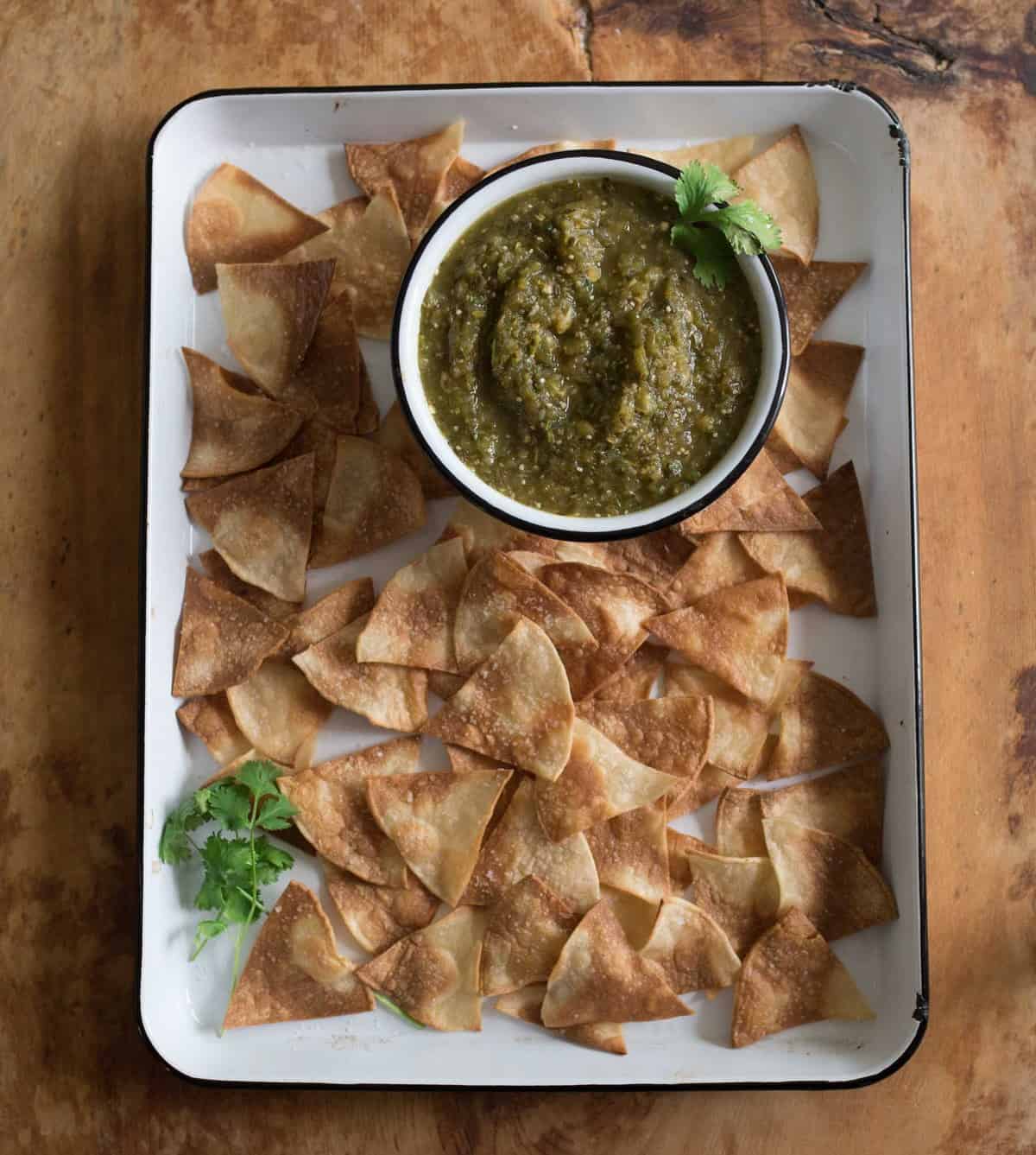 Quick and easy salsa verde recipe made with oven roasted tomatillos, peppers, onion, and garlic all blended to salsa perfection with a mix of herbs, spices, and lime juice.