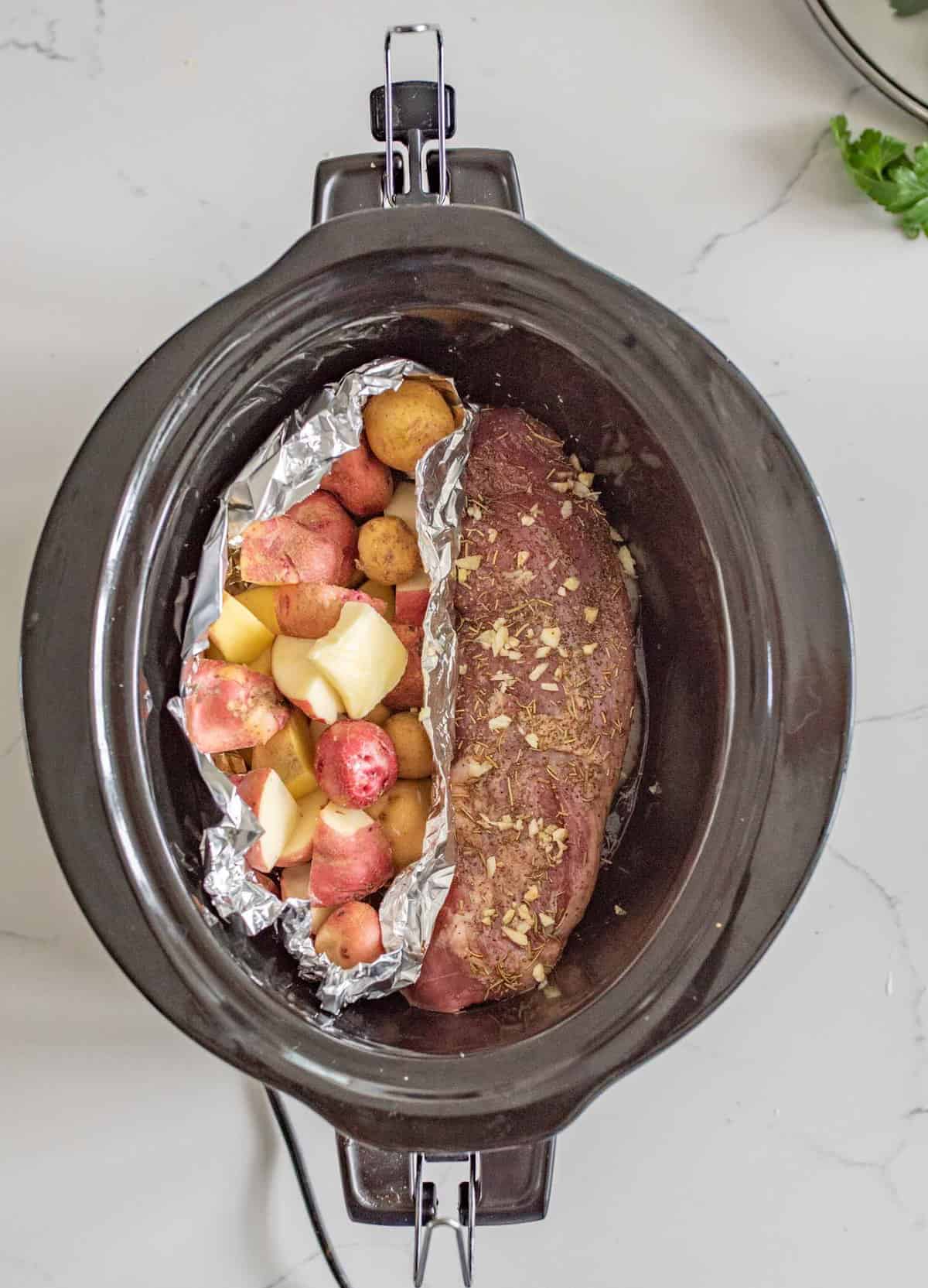 Slow Cooker Pork Tenderloin and Potatoes make the perfect simple dinner with moist and flavorful pork and potatoes that aren't over cooked or soggy.