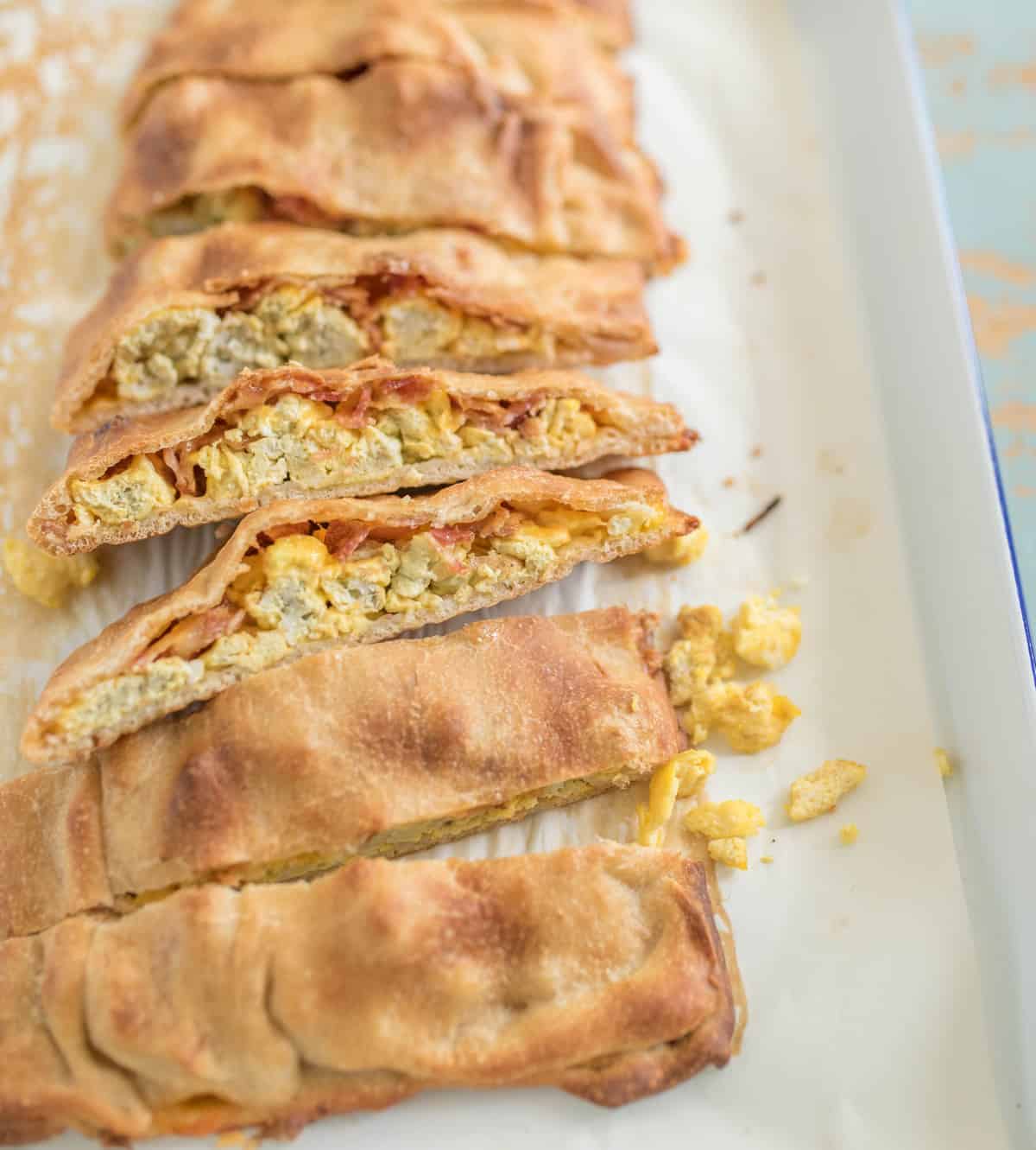Quick and easy breakfast pizza sticks made with pizza dough, eggs, bacon, and cheese, all baked into easy to eat pizza sticks.