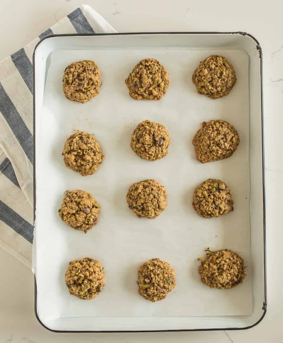 Chocolate Chip Oatmeal Zucchini cookies made with whole wheat flour, oats, chocolate chips, pecans, and shredded zucchini.