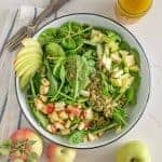 Bowl of spinach salad with apples and apple vinaigrette