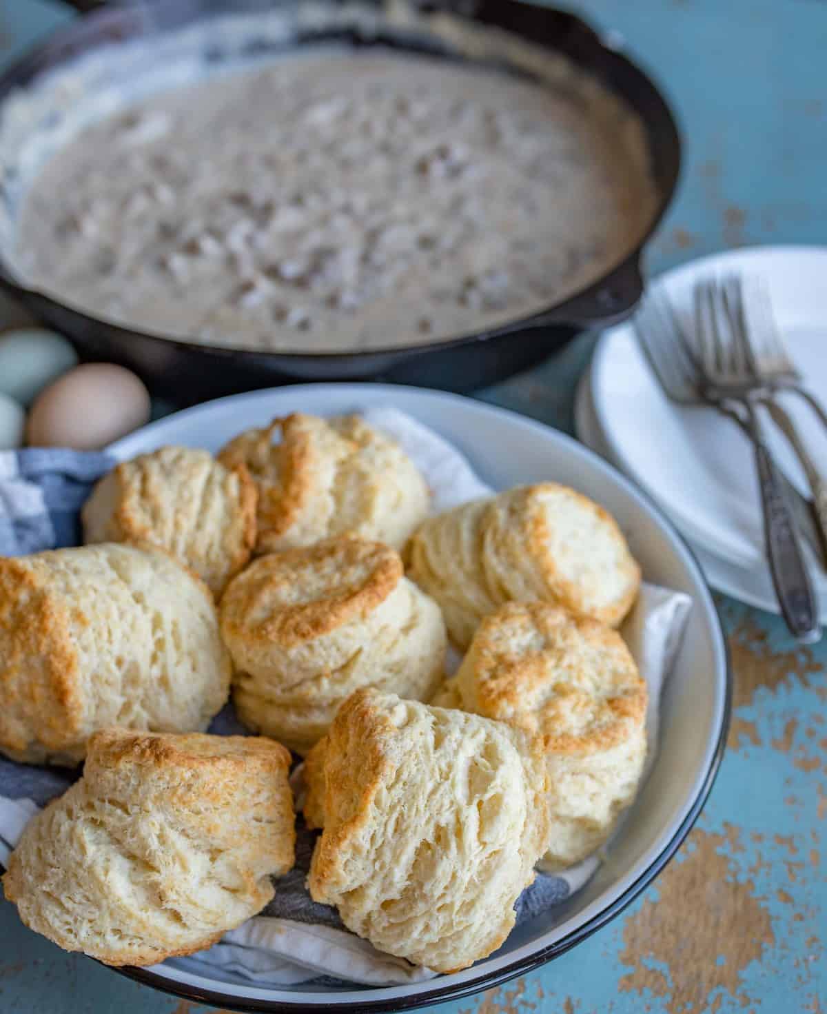 pan of biscuits ready to be served on a light blue table.