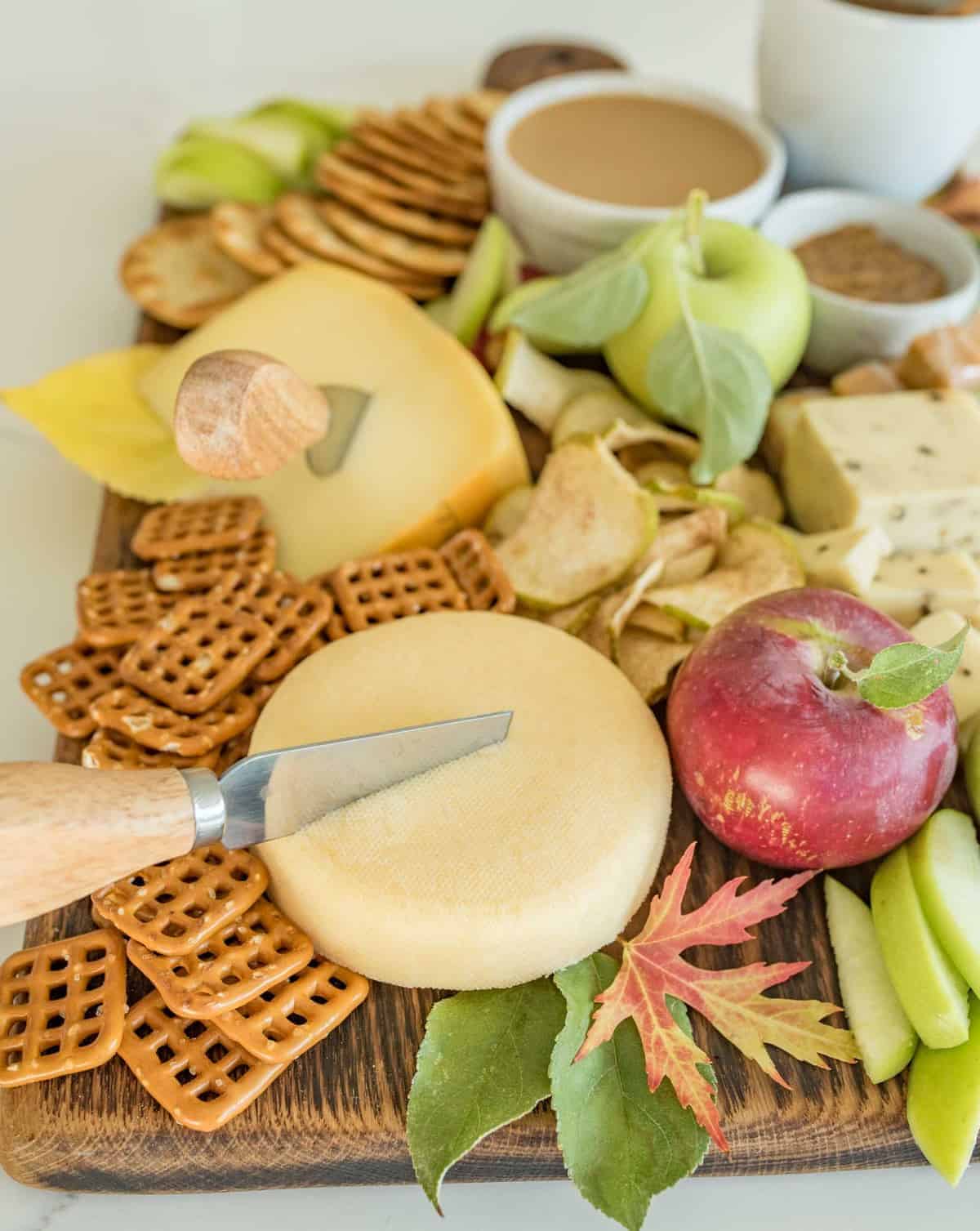 How to make a simple fall apple and cheese board that is perfect for snacking, an appetizer, parties, or just a slow evening in.