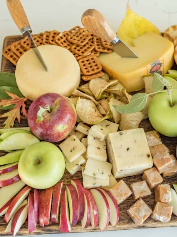 Platter with cheese, apple slices, crackers, and caramel dip