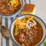 Two bowls of slow cooker chili with cornbread