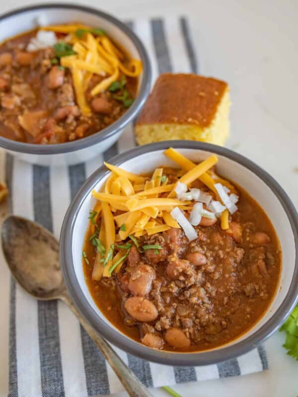 Two bowls of slow cooker chili with cornbread