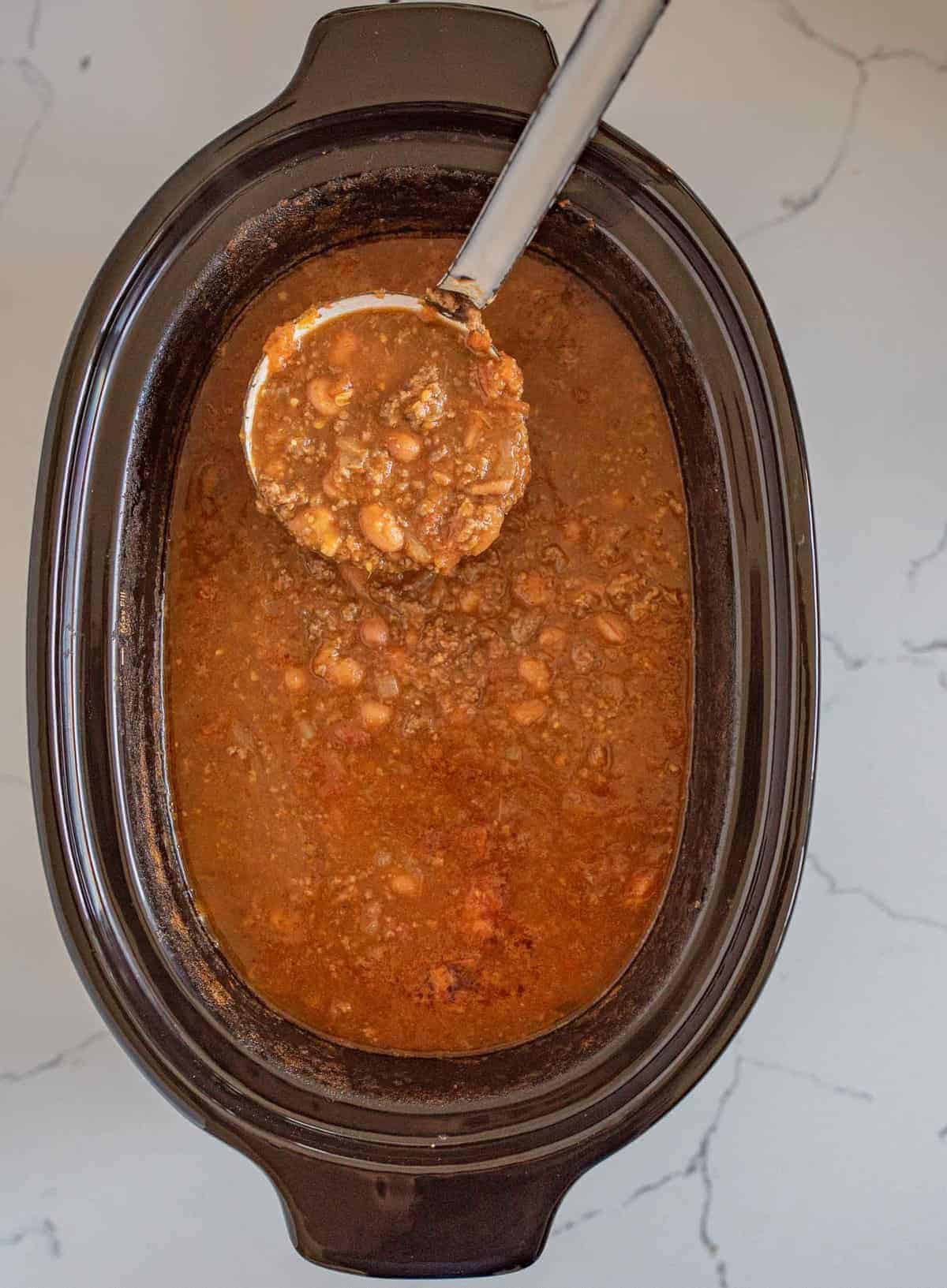 Quick and easy slow cooker chili made with all the classics like beans, tomatoes, and ground beef but contains two other surprising ingredients that will add tons of flavor with no extra work.