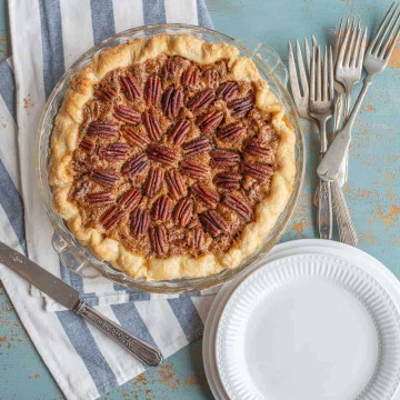 Image of a pecan pie with some plates