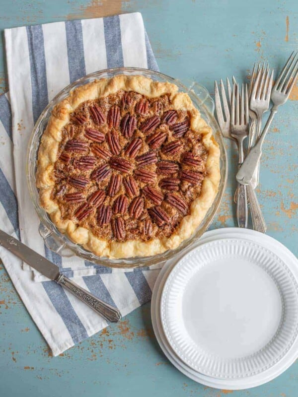 Image of a pecan pie with some plates.