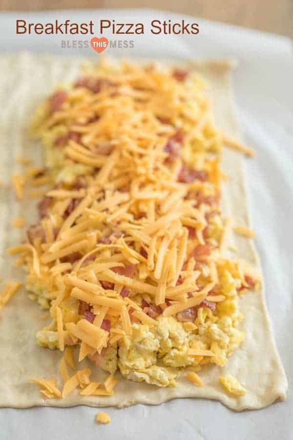 Quick and easy breakfast pizza sticks made with pizza dough, eggs, bacon, and cheese, all baked into easy to eat pizza sticks. 