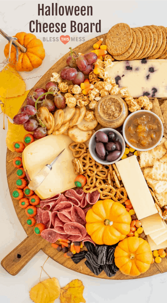 Title Image for Halloween Cheese Board with crackers, pretzels, cheeses, meats, fall-colored candies, mini gourds