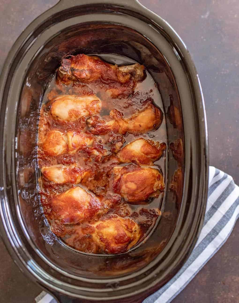slow cookers in a black crock pot with lots of sauce