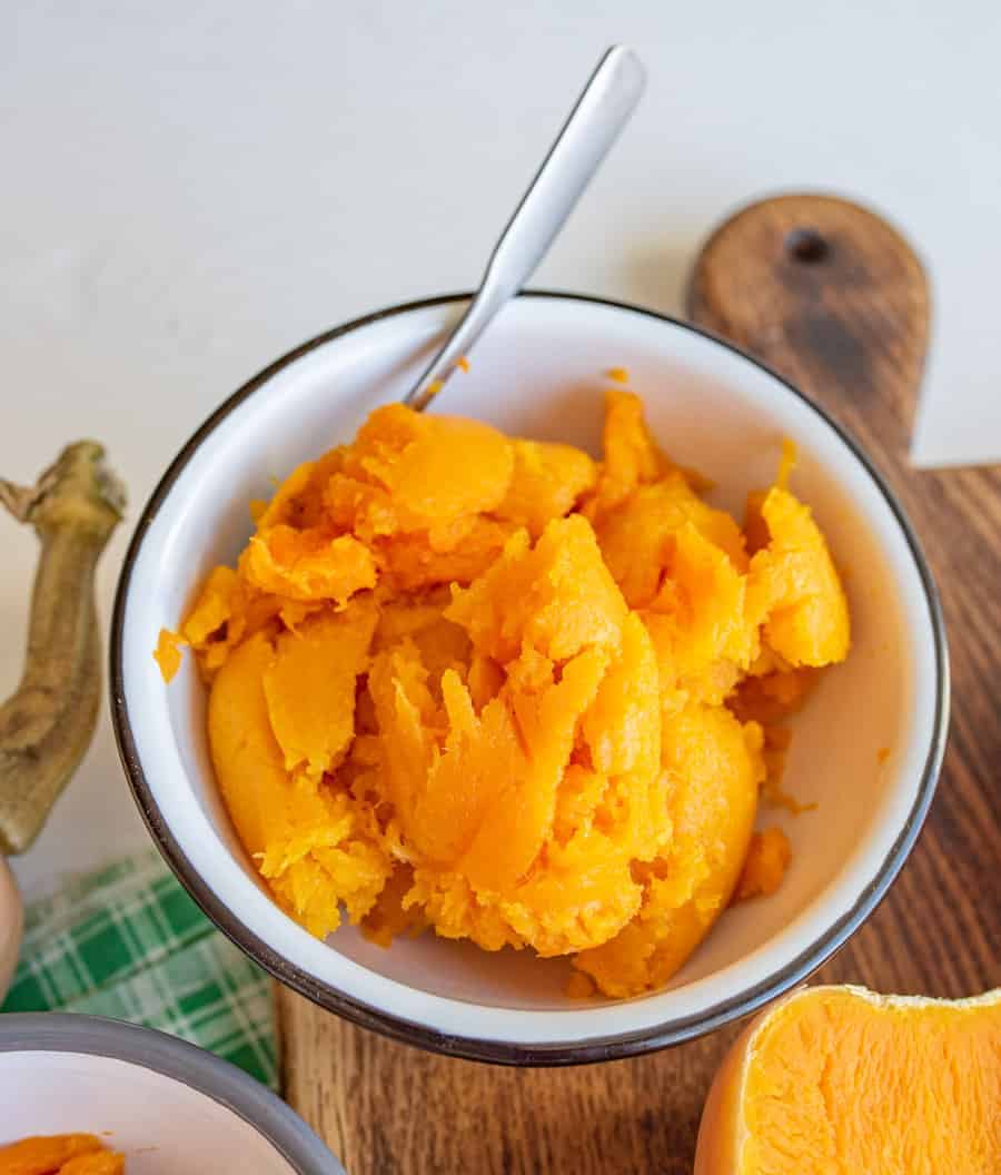 An image of a white bowl filled with cooked butternut squash.