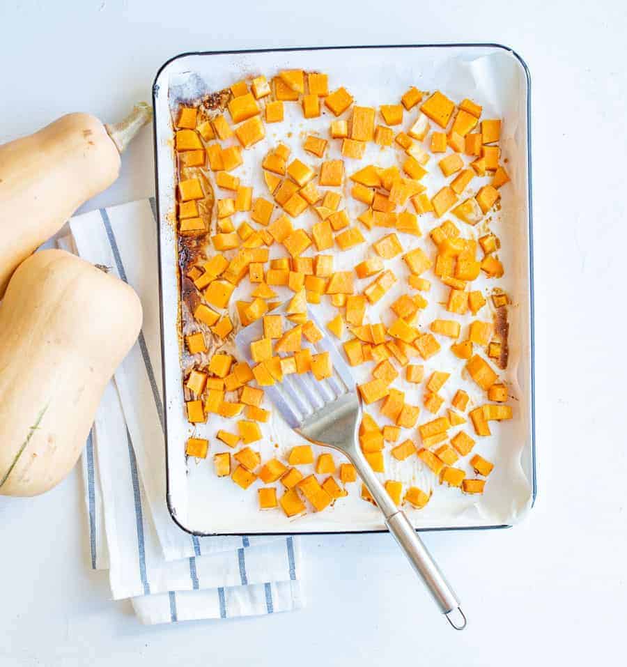 Quick and easy recipe for maple roasted butternut squash cubes that are cooked in the oven and make a perfect healthy side dish.