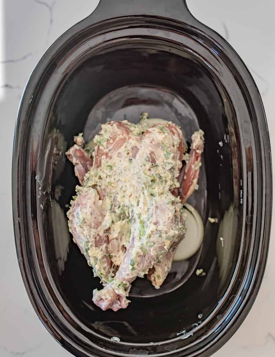 A simple way to cook whole chicken in the crock pot by using lots of fresh herbs and butter for an extra tender and delicious chicken with very little hands on prep time.