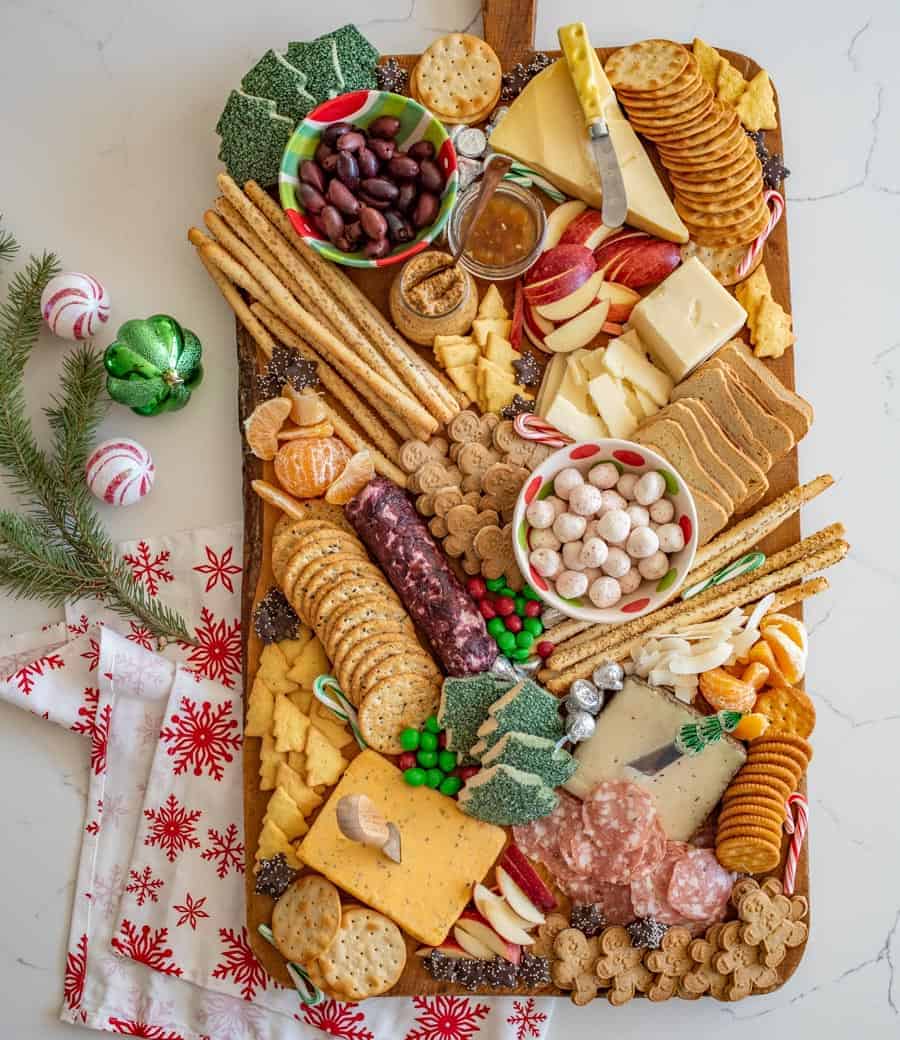 How to make a DIY Christmas Cheese board for a party complete with what cheese to buy, how to make it festive, and more!