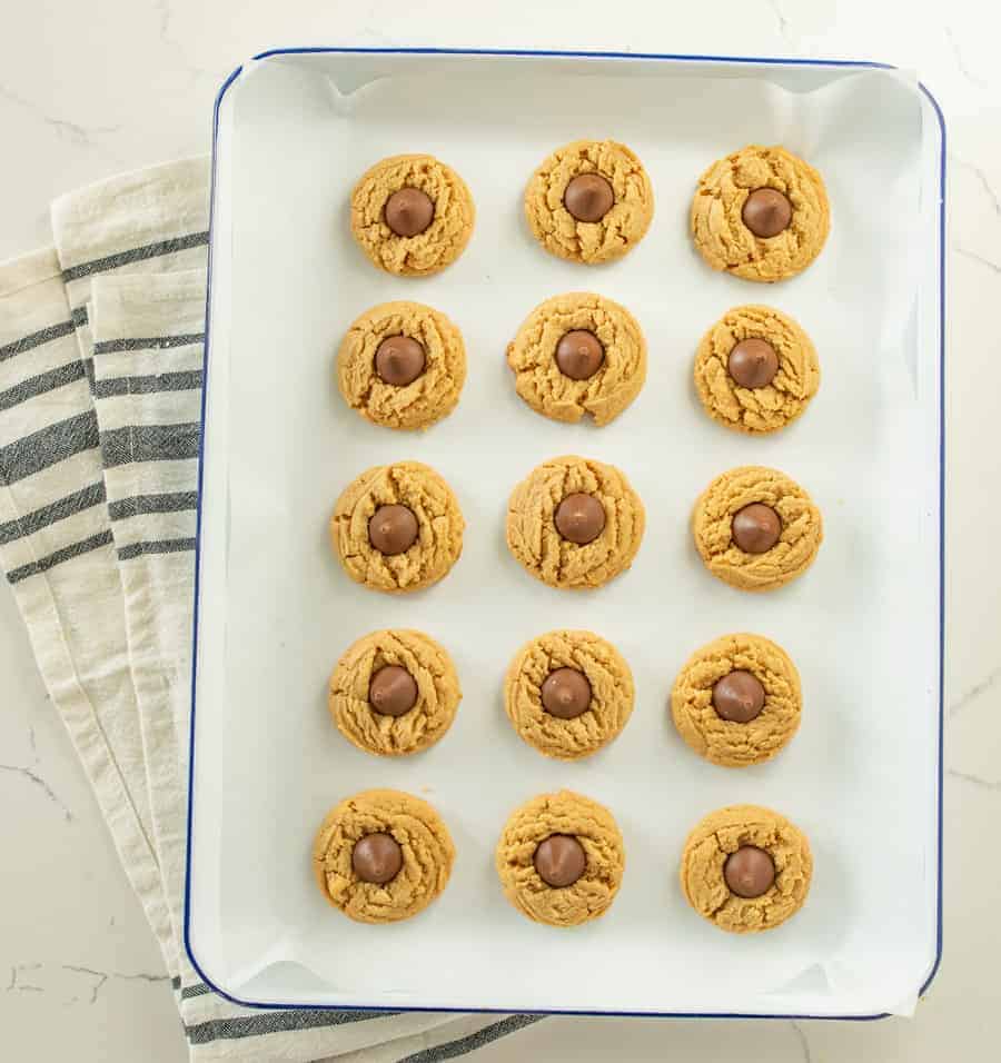 The best peanut butter blossoms made with a thick, soft, and chewy peanut butter cookies and a chocolate kisses pressed in the middle. 