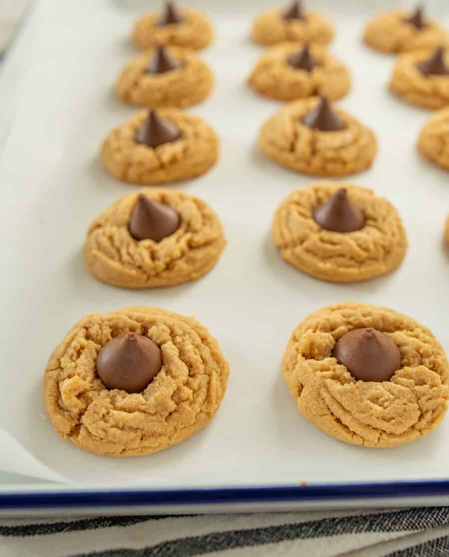 The best peanut butter blossoms made with a thick, soft, and chewy peanut butter cookies and a chocolate kisses pressed in the middle.