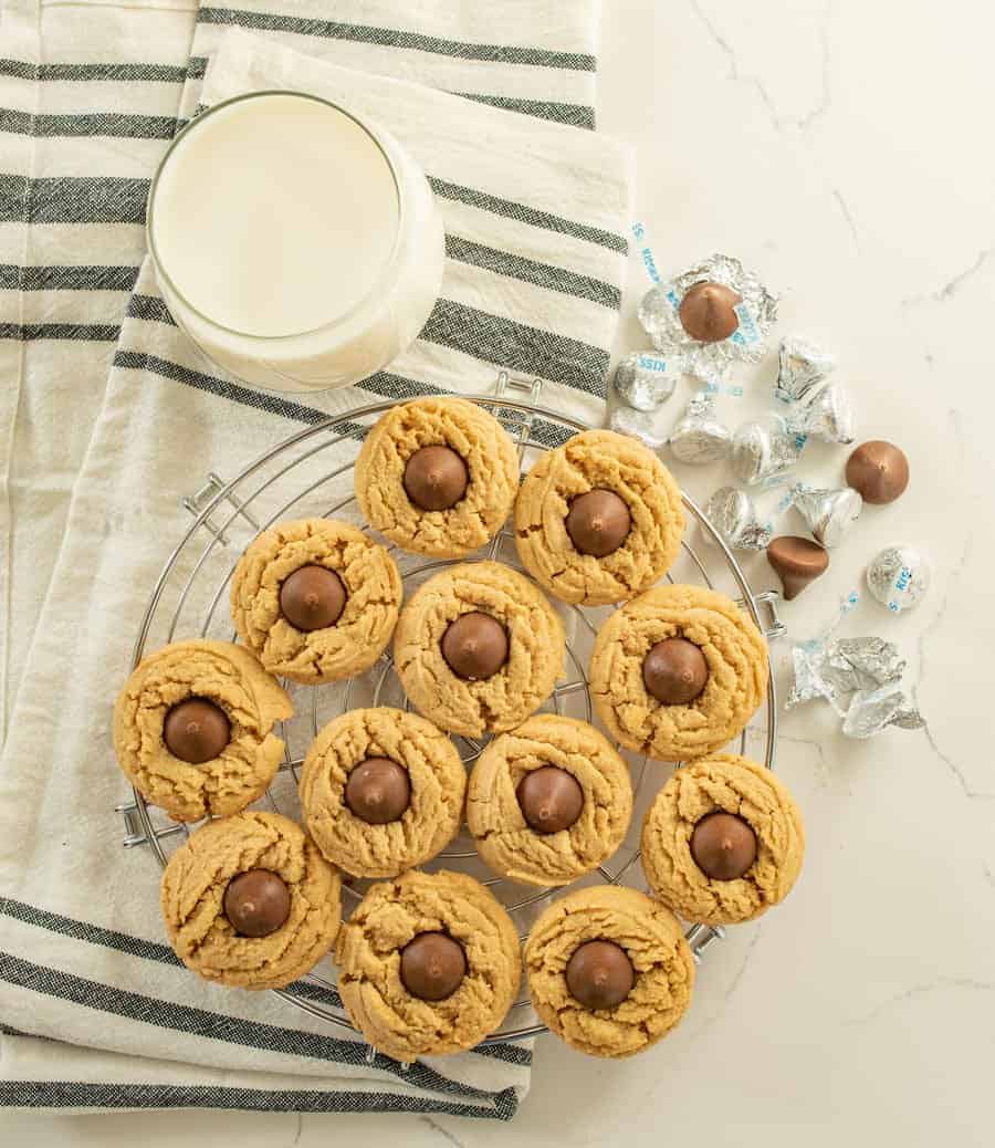 The best peanut butter blossoms made with a thick, soft, and chewy peanut butter cookies and a chocolate kisses pressed in the middle.