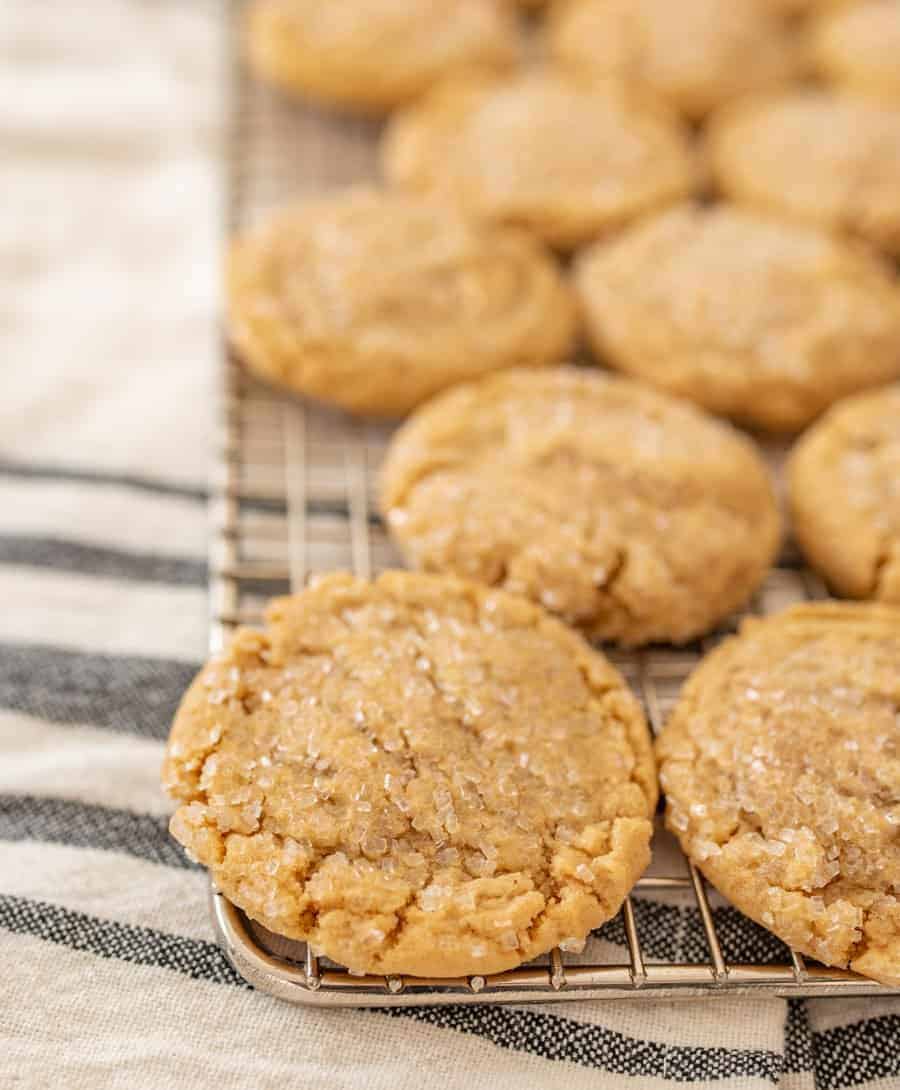 Close up of peanut butter cookie, showing its crispy outside and sugar coating.