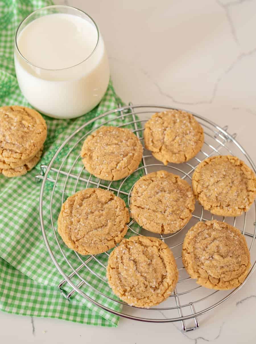 Peanut butter cookies arranged on a baking rack.