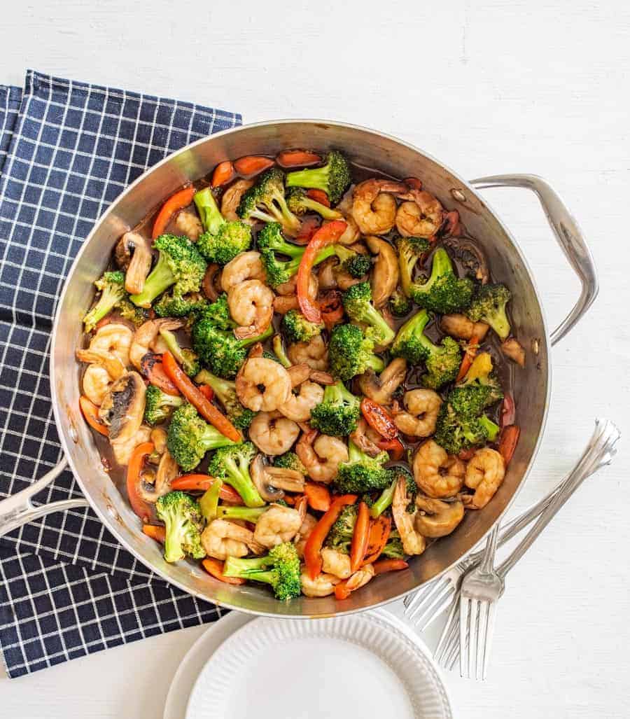 Top view of pan of stir fry from the top on a checkered napkin