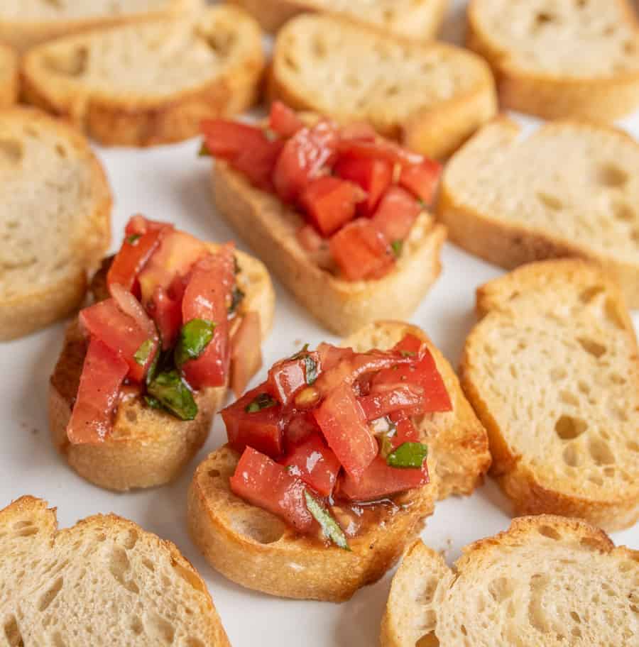 A simple and fresh appetizer, Summer Tomato Bruschetta brings lively flavors of tomato and basil to crunchy, well-buttered slices of toasted baguette.