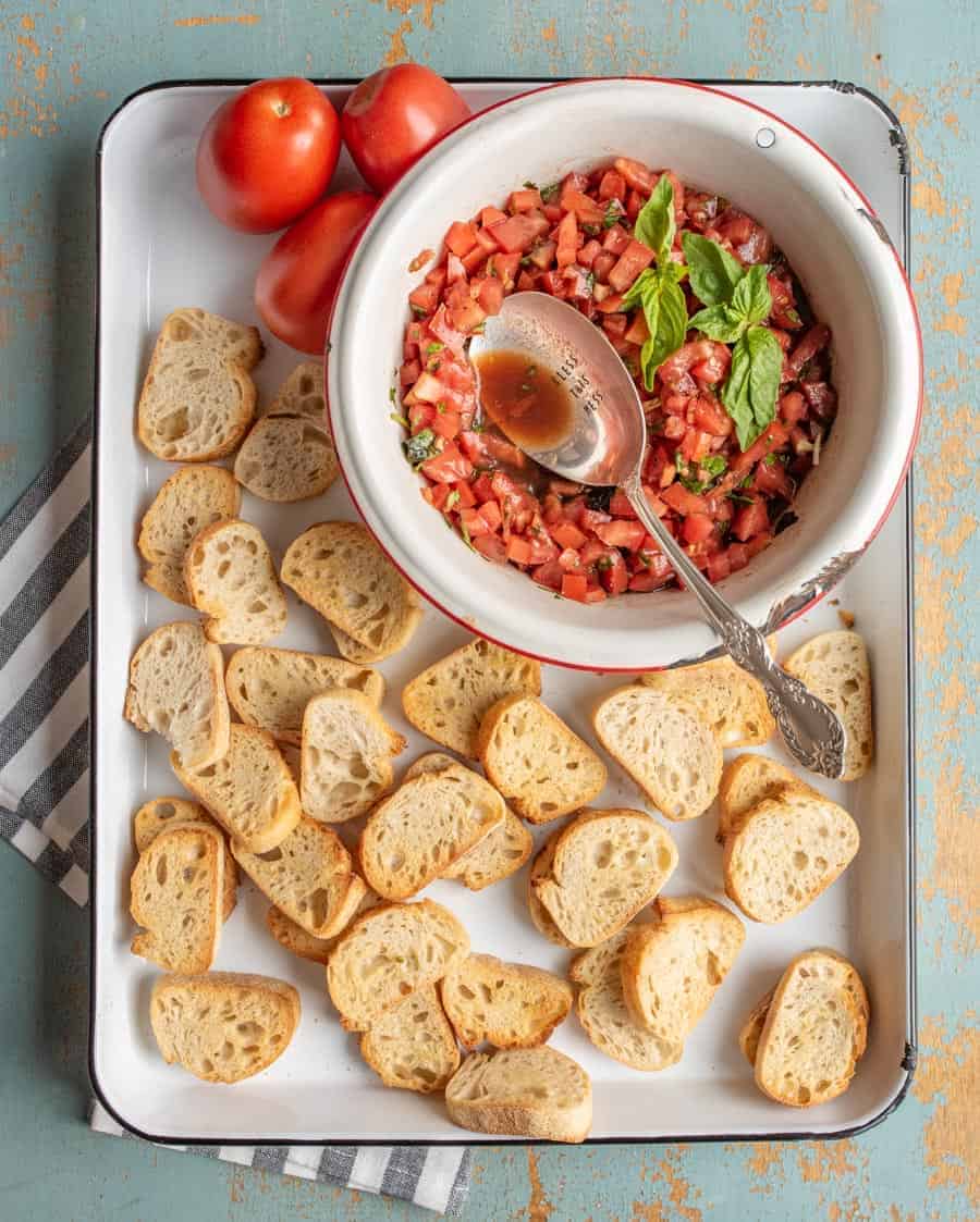 A simple and fresh appetizer, Summer Tomato Bruschetta brings lively flavors of tomato and basil to crunchy, well-buttered slices of toasted baguette.