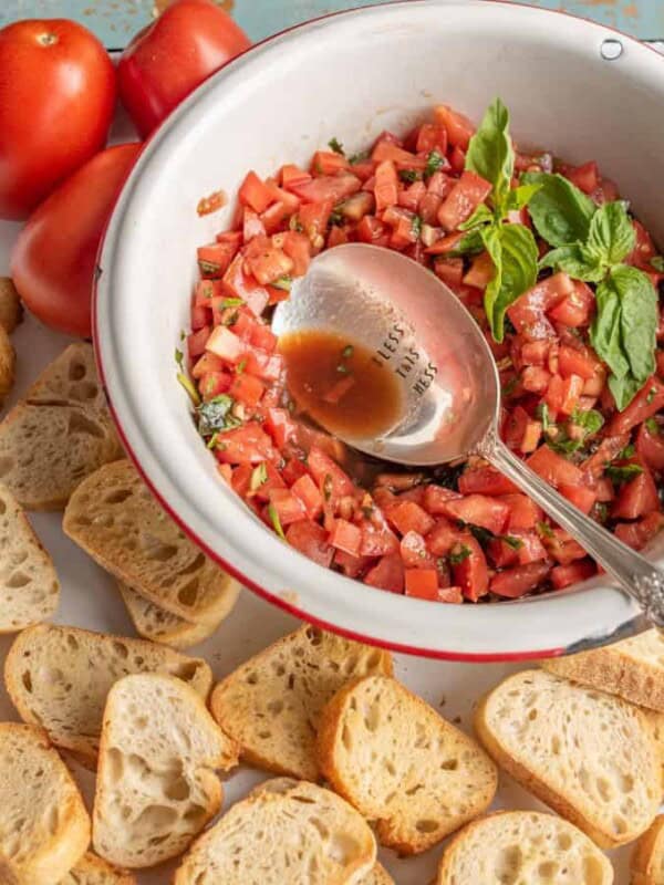 A simple and fresh appetizer, Summer Tomato Bruschetta brings lively flavors of tomato and basil to crunchy, well-buttered slices of toasted baguette.