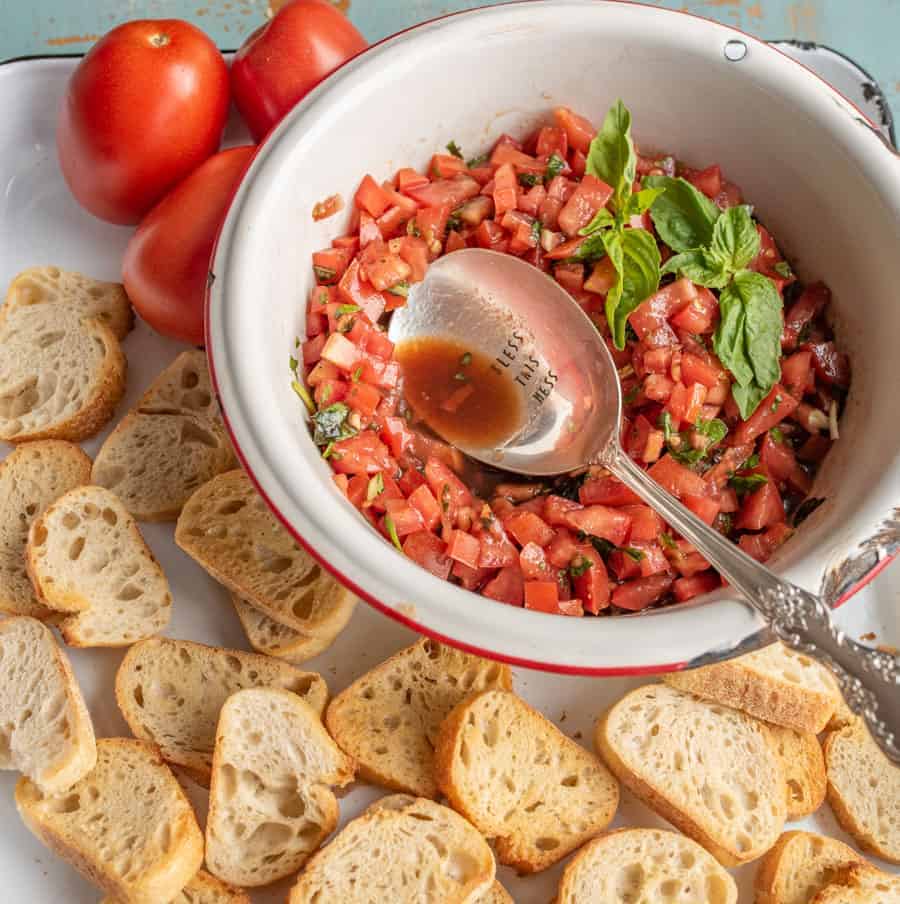 A simple and fresh appetizer, Summer Tomato Bruschetta brings lively flavors of tomato and basil to crunchy, well-buttered slices of toasted baguette.