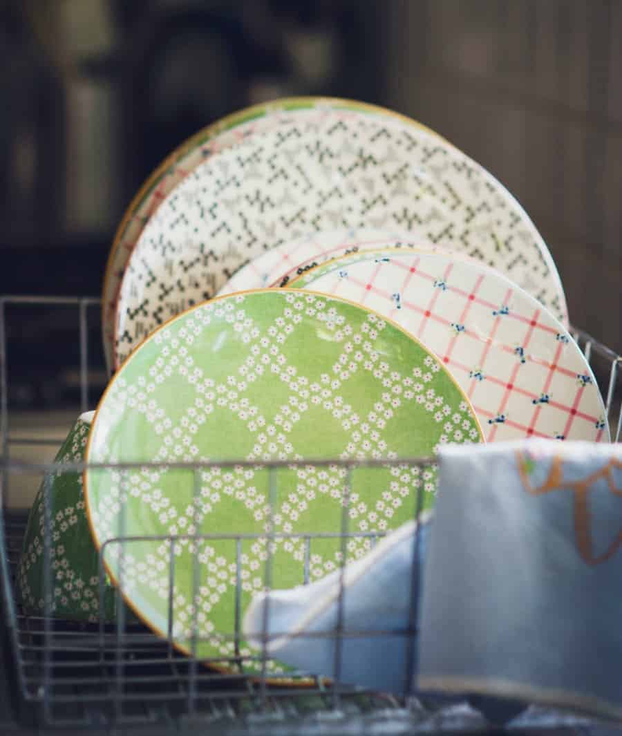 Image of clean dishes in a dish rack. 