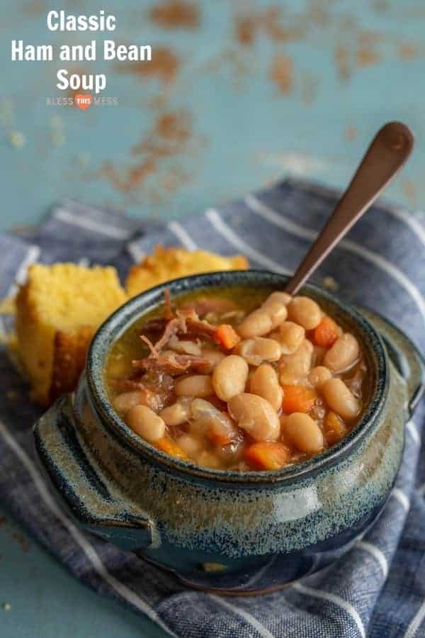 Title Image for Classic Ham and Bean Soup and a crock of ham and bean soup with cornbread on a striped cloth