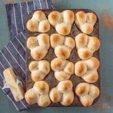 Grandma Lucy's famous clover rolls that are extra soft and fluffy, easy to shape, and a perfect recipe for little hands to help bake.