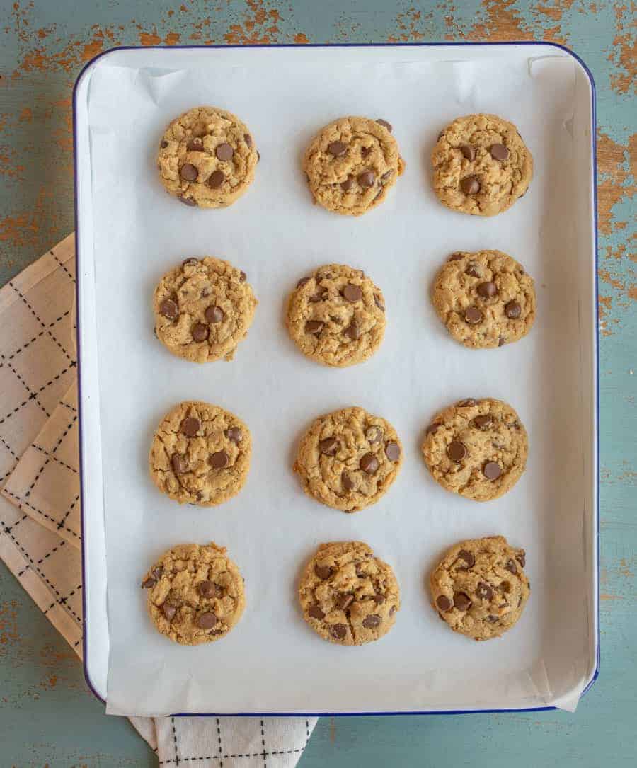 an overhead shot of peanut butter chocolate chip cookies on a white tray.