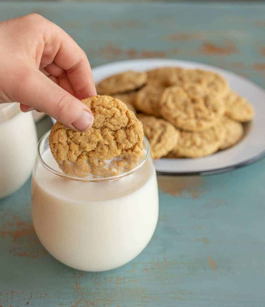 cookie dipped in glass of milk