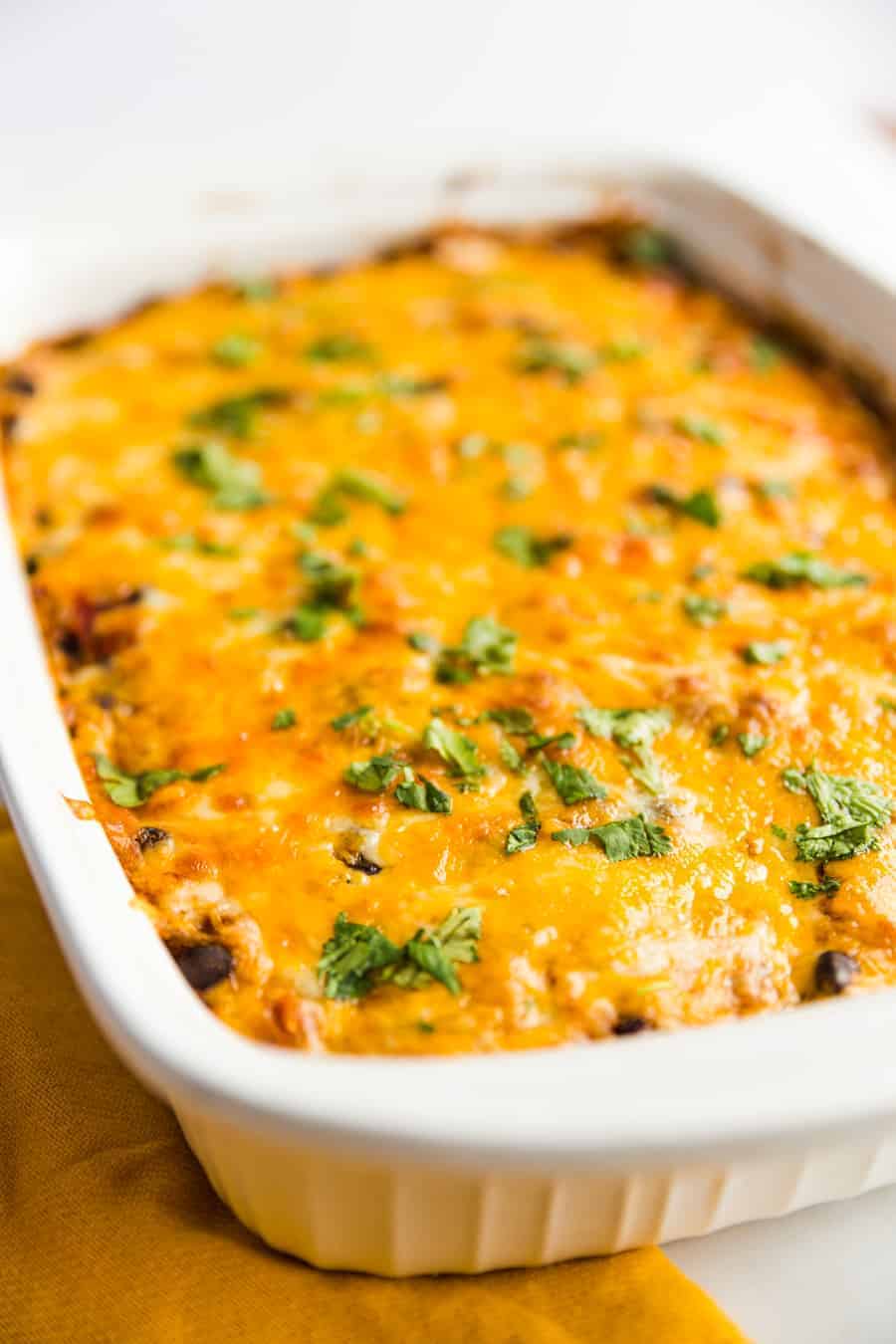 This easy, meatless meal is like a rice-and-bean-layered enchilada casserole. Topped with green or red enchilada sauce (you pick!) and cheese, you'll be satisfied with this savory rendition of a classic Tex-Mex dish.