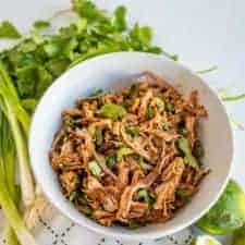 This crockpot Cafe Rio sweet pork barbacoa recipe is a lifesaver for busy weeknights. I love a good “toss it all in the slow cooker and forget about it ‘til dinner time” meal, don’t you?