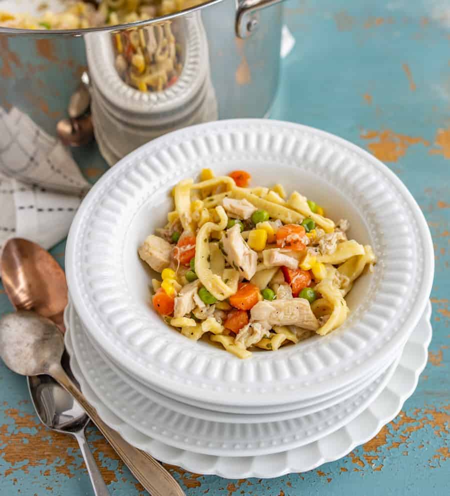 This comforting Chunky Chicken Noodle Soup will brighten any gloomy day and combat any head cold with its hearty combination of shredded chicken (or turkey), egg noodles, carrots, peas, corn, and lots of flavor-packing spices.