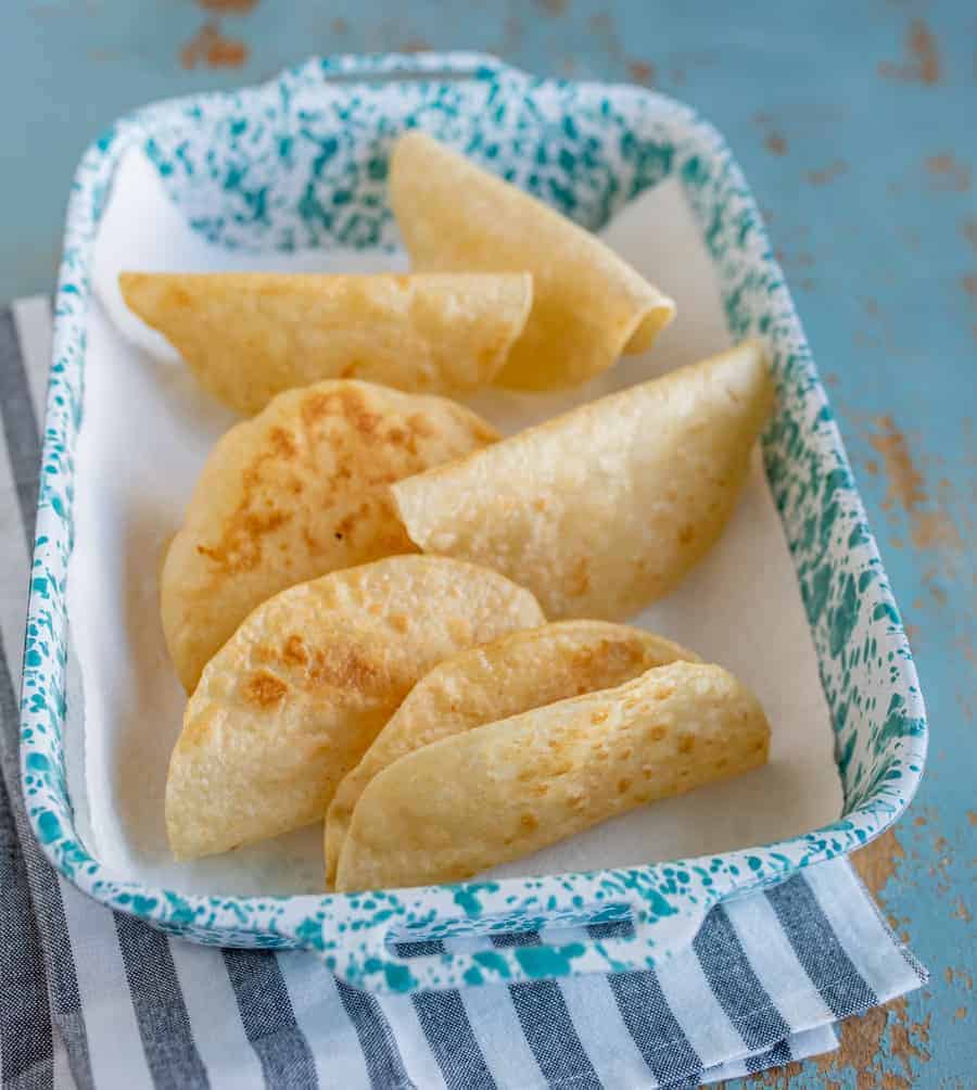 an overhead shot of a pan filled with crispy corn tortilla shells.