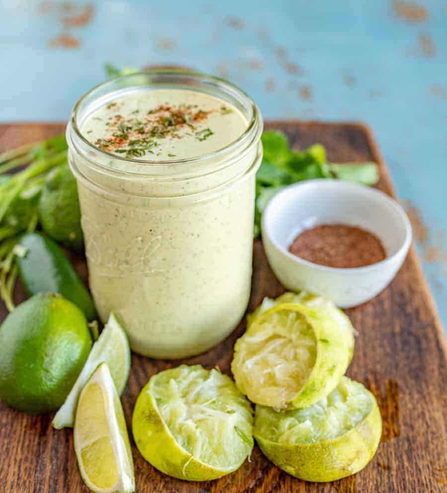 Rich and Creamy Cilantro Lime Dressing made with green salsa, mayo, and more that is perfect for your favorite taco salad or to add to nachos!