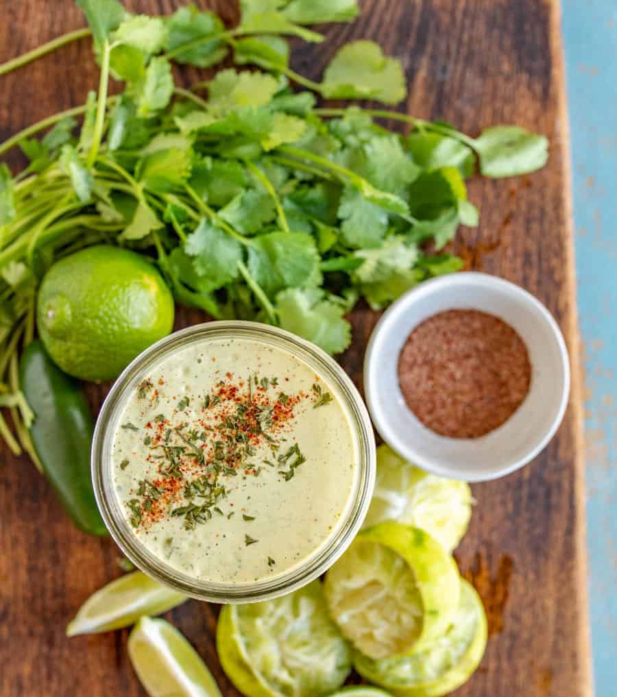 Rich and Creamy Cilantro Lime Dressing made with green salsa, mayo, and more that is perfect for your favorite taco salad or to add to nachos!